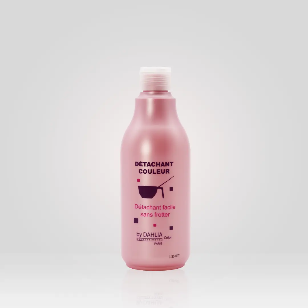 Un flacon détachant rose Détachant Couleur 500 ml avec texte français se détache sur un fond clair uni, parfait pour ceux qui recherchent le rapport qualité/prix dans un Dahlia Color ou un produit capillaire professionnel bon marché. Dahlia Color Professionnel